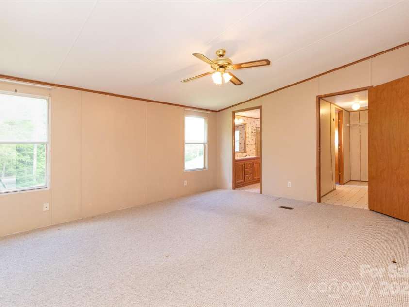 283 Grandview Drive, Marshall, NC 28753.  MLS# CAR4256159, YatesRealty ID 16074. Large primary bedroom with walk-in closet