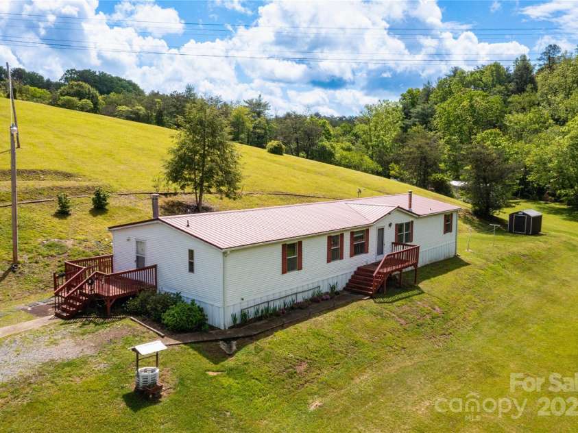 283 Grandview Drive, Marshall, NC 28753.  MLS# CAR4256159, YatesRealty ID 16074. Raised garden beds behind the home