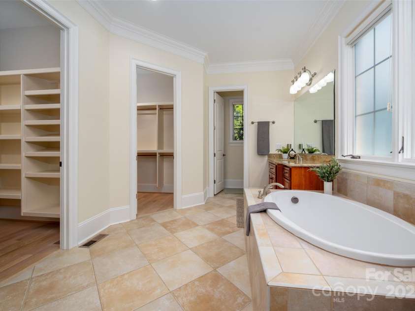 1500 Tarrington Way, Wesley Chapel, NC 28079.  MLS# CAR4260125, YatesRealty ID 16079. His and her closets with wood shelfing