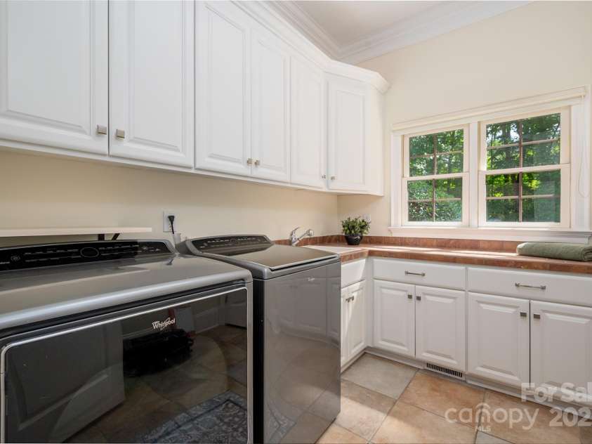 1500 Tarrington Way, Wesley Chapel, NC 28079.  MLS# CAR4260125, YatesRealty ID 16079. Large main floor laundry with sink - Washer/Dryer Convey
