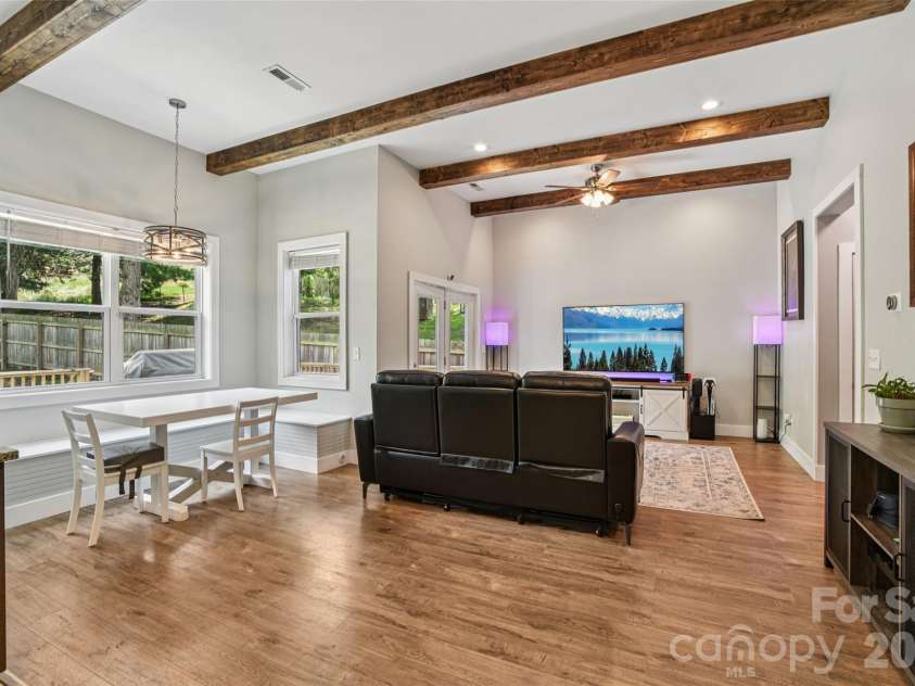 8 Apple Lane, Asheville, NC 28804.  MLS# CAR4354022, YatesRealty ID 16087. Living area has easy access to a sun-filled back deck