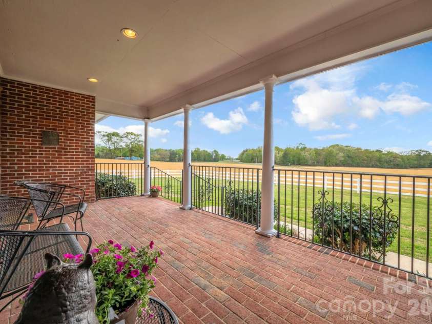 824 Forest Hills School Road, Marshville, NC 28103.  MLS# CAR4353815, YatesRealty ID 16088. Covered front porch overlooking fields
