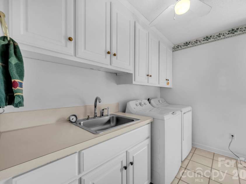 824 Forest Hills School Road, Marshville, NC 28103.  MLS# CAR4353815, YatesRealty ID 16088. Laundry/mud/office with cabinets, sink and tile flooring