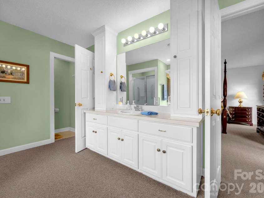 824 Forest Hills School Road, Marshville, NC 28103.  MLS# CAR4353815, YatesRealty ID 16088. Primary bathroom with two vanities and two water closets