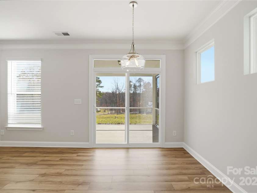 6027 Veld Court, Charlotte, NC 28215.  MLS# CAR4257024, YatesRealty ID 16096. Breakfast area leads to screened porch