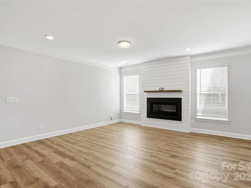 6027 Veld Court, Charlotte, NC 28215.  MLS# CAR4257024, YatesRealty ID 16096. Family room with fireplace and shiplap wall