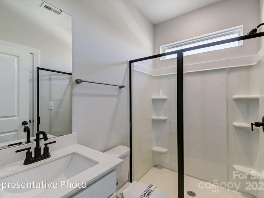 6027 Veld Court, Charlotte, NC 28215.  MLS# CAR4257024, YatesRealty ID 16096. Guest bath will feature a 4ft shower with bench seat