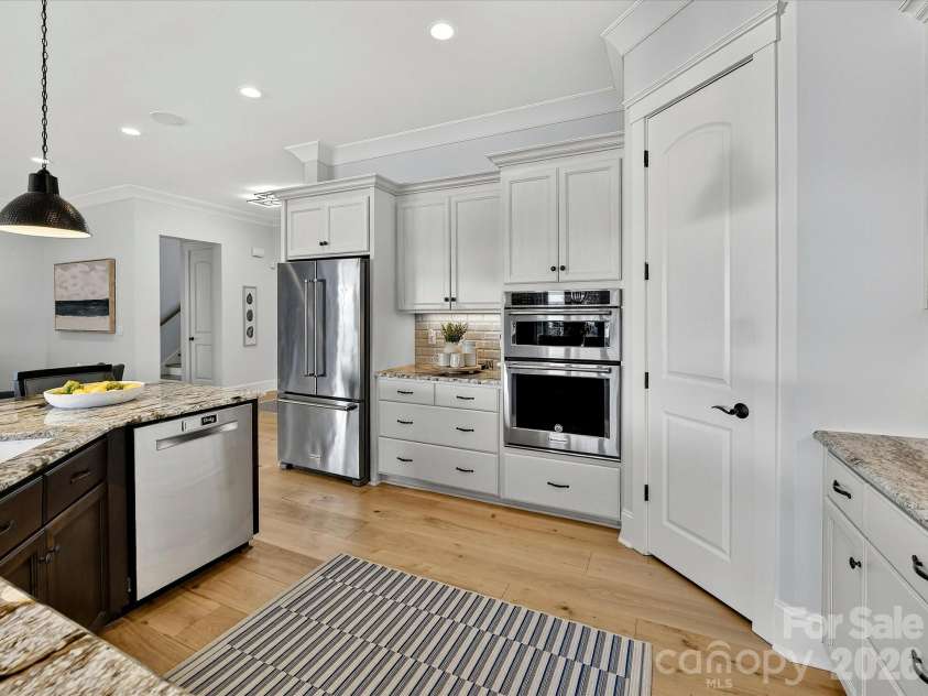 18014 Whispering Oaks Drive, Cornelius, NC 28031.  MLS# CAR4356897, YatesRealty ID 16097. Entertain with ease in the beautifully designed kitchen complete with an oversized island, double ovens, abundant cabinetry, and an open-concept layout that flows throughout the home.