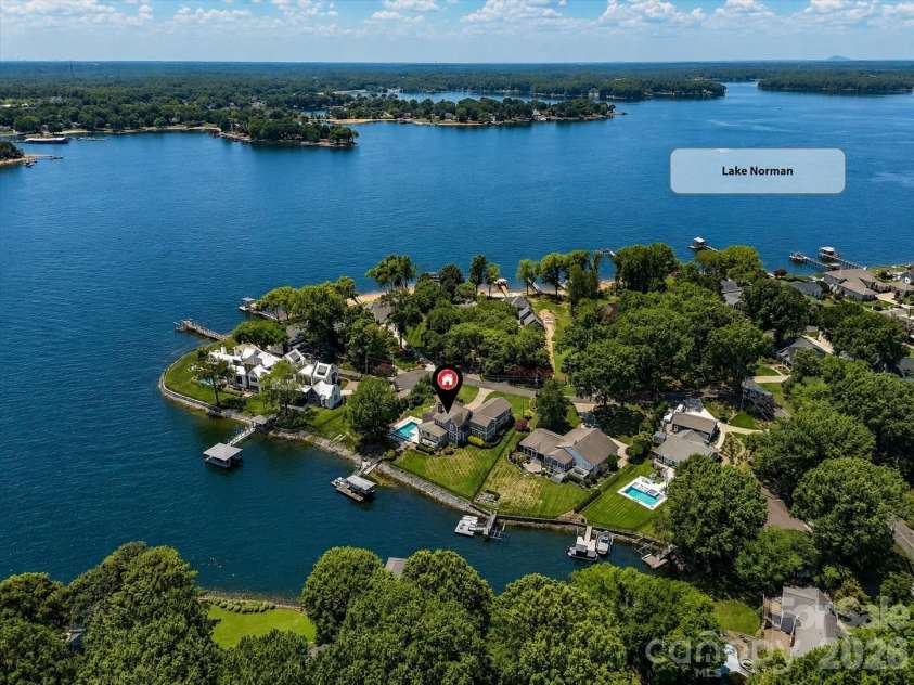 18014 Whispering Oaks Drive, Cornelius, NC 28031.  MLS# CAR4356897, YatesRealty ID 16097. Exceptional Lake Norman waterfront setting with expansive main channel views, a private dock, and an ideal location for enjoying the best of lakefront living. (Virtually enhanced lake levels)