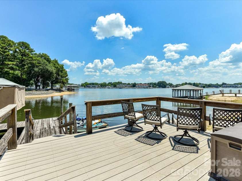 18014 Whispering Oaks Drive, Cornelius, NC 28031.  MLS# CAR4356897, YatesRealty ID 16097. Private dock offers the perfect setting to relax, entertain, or launch your next day on the lake while enjoying expansive open water views.