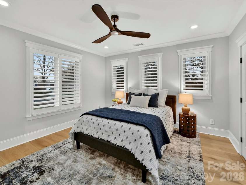 18014 Whispering Oaks Drive, Cornelius, NC 28031.  MLS# CAR4356897, YatesRealty ID 16097. Spacious secondary bedroom features abundant natural light, plantation shutters, hardwood floors, and generous closet space for family or guests.