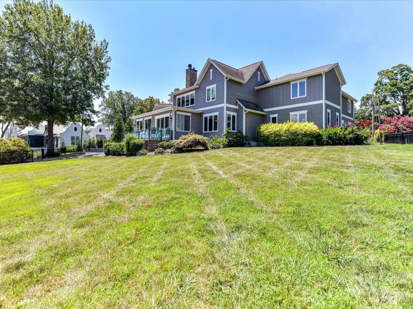 18014 Whispering Oaks Drive, Cornelius, NC 28031.  MLS# CAR4356897, YatesRealty ID 16097. The expansive, level backyard offers plenty of space for recreation, entertaining, and enjoying peaceful lake views in a beautifully landscaped setting.