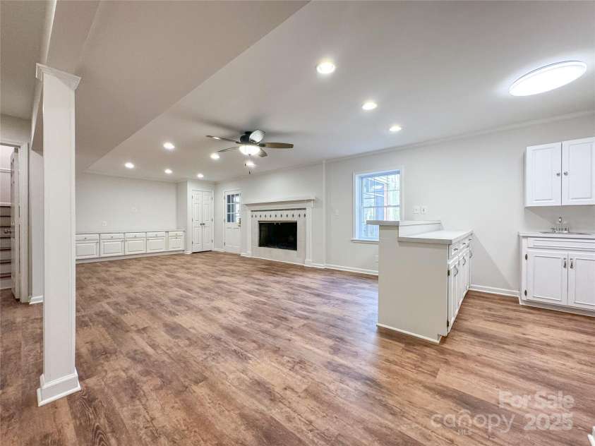 12011 Stoney Meadow Drive, Mint Hill, NC 28227.  MLS# CAR4240871, YatesRealty ID 16104. Downstairs rec-room with wet bar and wood-burning fireplace