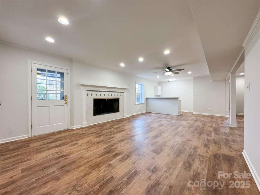 12011 Stoney Meadow Drive, Mint Hill, NC 28227.  MLS# CAR4240871, YatesRealty ID 16104. Downstairs rec-room with wet bar and wood-burning fireplace