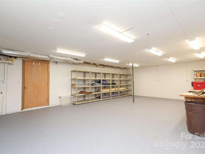 1333 Carlton Avenue, Charlotte, NC 28203.  MLS# CAR4211721, YatesRealty ID 16118. Huge Basement Workshop w/storage shelves