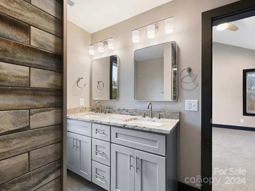 52 Fox Drive, Asheville, NC 28803.  MLS# CAR4201409, YatesRealty ID 16120. Double sink vanity in Primary BR