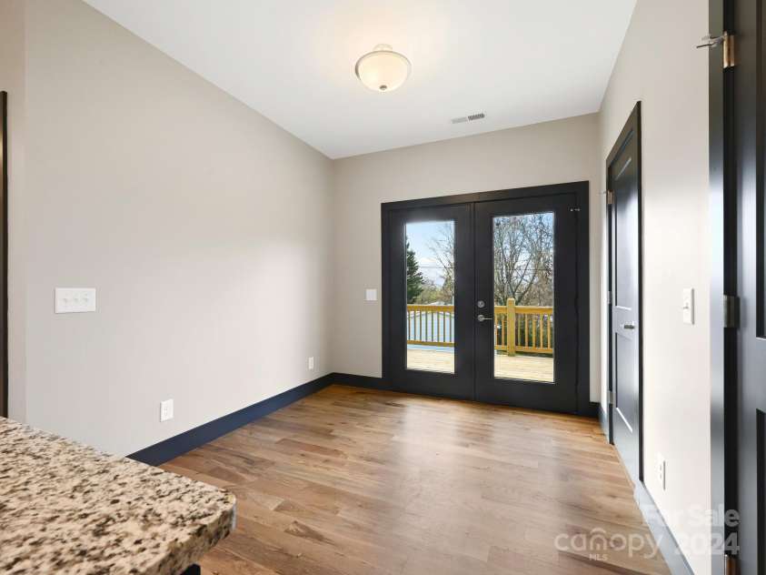 52 Fox Drive, Asheville, NC 28803.  MLS# CAR4201409, YatesRealty ID 16120. Keeping Room leads to side deck