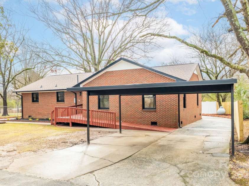 407 Thomas Street, Marshville, NC 28103.  MLS# CAR4216955, YatesRealty ID 16127. Detached carport in addition to a wrap around driveway.
