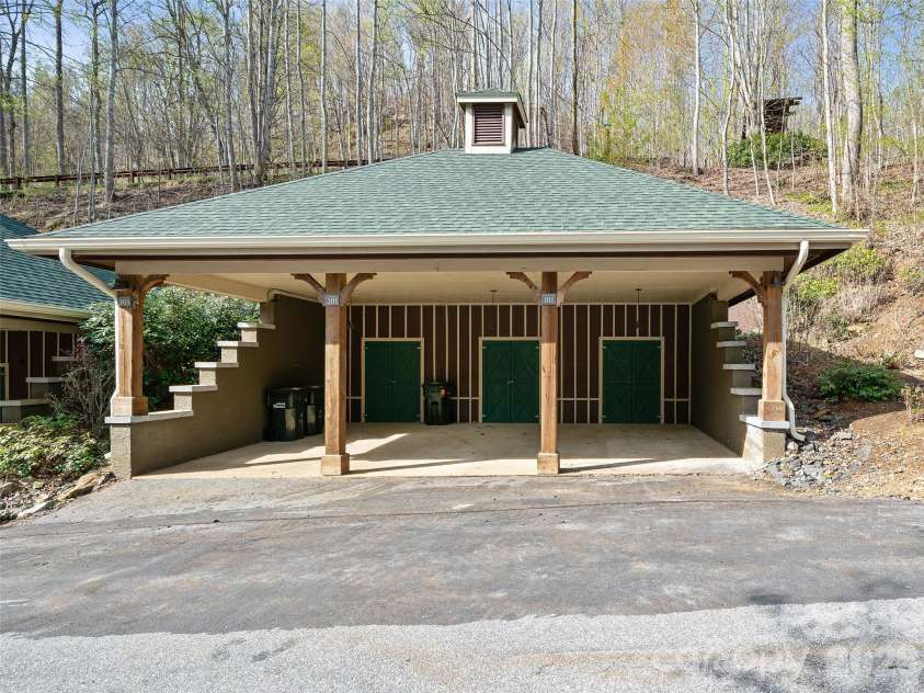81 Creekside Way, Burnsville, NC 28714.  MLS# CAR4374251, YatesRealty ID 16129. Carport with lockable storage unit to back