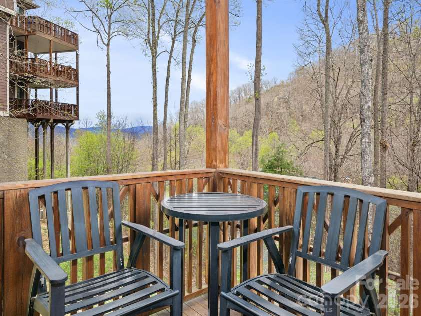 81 Creekside Way, Burnsville, NC 28714.  MLS# CAR4374251, YatesRealty ID 16129. Long range Mountain views from the covered porch area