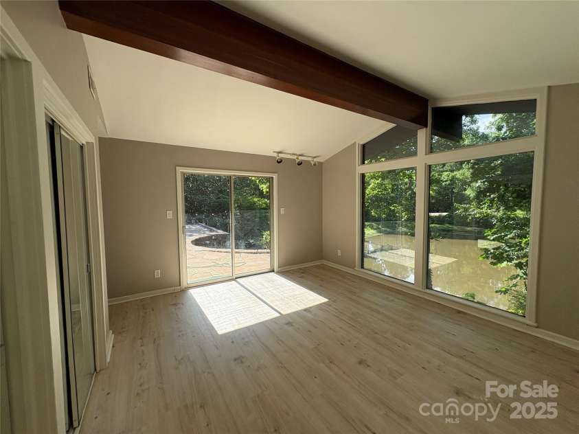 223 Forest Drive, Greenwood, SC 29646.  MLS# CAR4264303, YatesRealty ID 16134. Primary bedroom has access to rear patio and great views of pond.