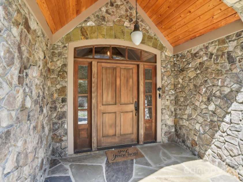 206 View Ridge Parkway, Leicester, NC 28748.  MLS# CAR4228261, YatesRealty ID 16135. A captivating stone front porch sets the tone with timeless charm and inviting warmth—the perfect welcome home