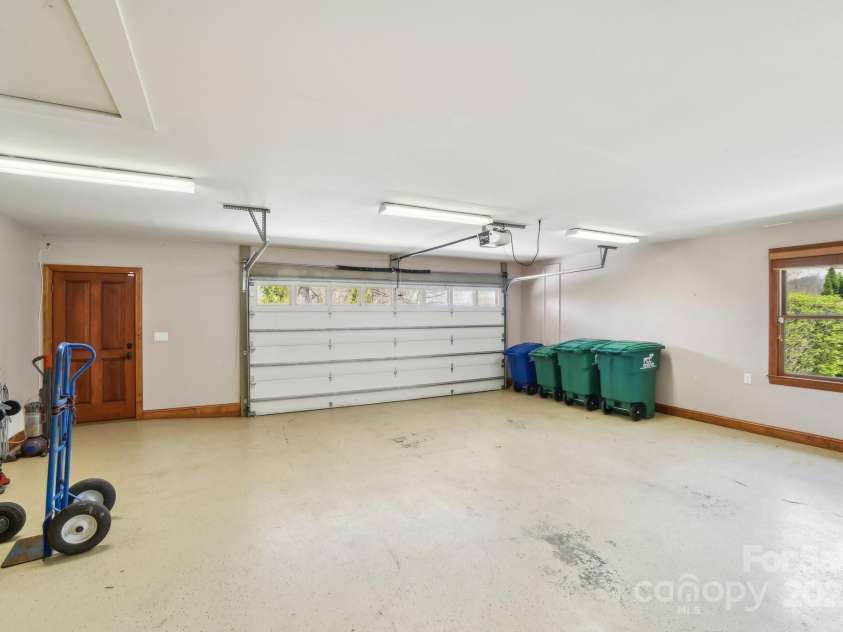 206 View Ridge Parkway, Leicester, NC 28748.  MLS# CAR4228261, YatesRealty ID 16135. Spacious double garage with extra storage room, offering plenty of space for vehicles, tools, and more