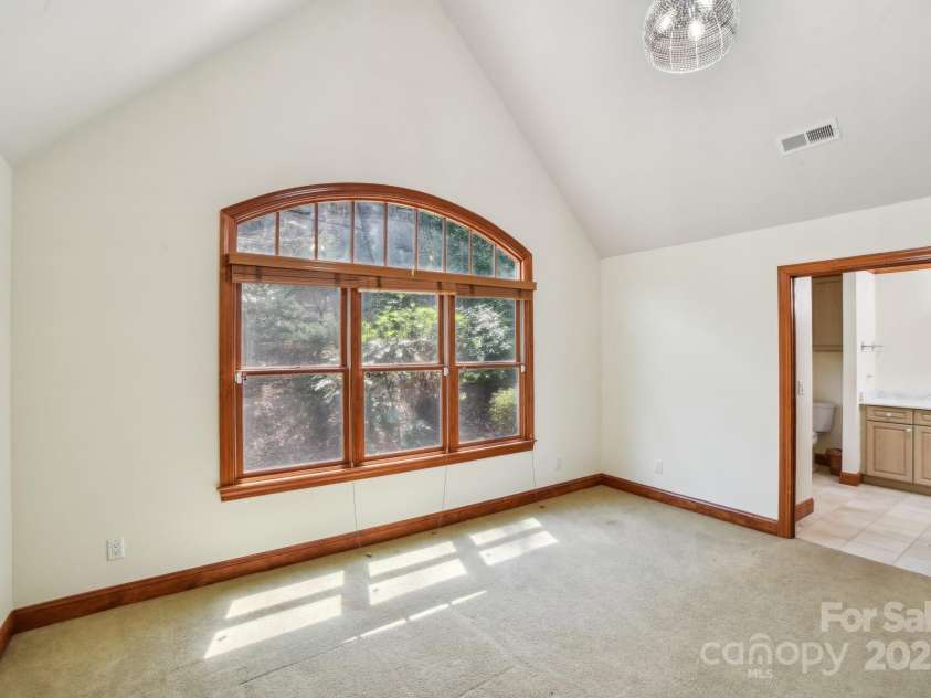 206 View Ridge Parkway, Leicester, NC 28748.  MLS# CAR4228261, YatesRealty ID 16135. The second bedroom is bathed in natural light, with carpeting and a welcoming, comfortable atmosphere