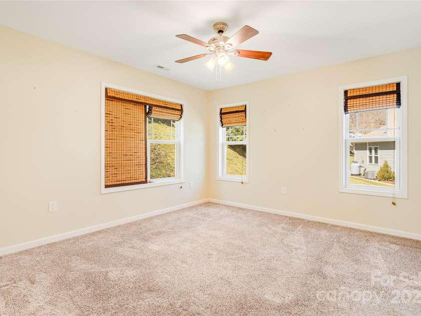 269 February Lane, Waynesville, NC 28785.  MLS# CAR4227476, YatesRealty ID 1614. Primary bedroom
