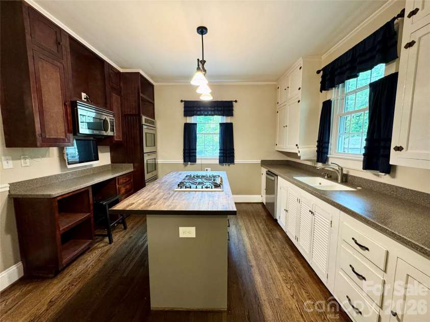 70 Washington Lane, Concord, NC 28025.  MLS# CAR4371911, YatesRealty ID 16153. Kitchen with solid surface countertops around the perimeter and butcher block island top