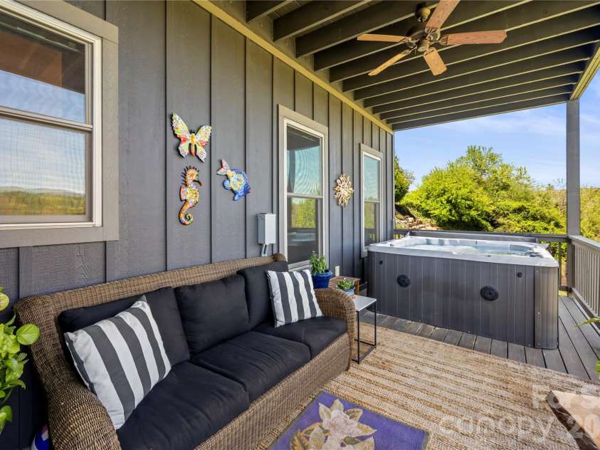 28 Gracie Lane, Weaverville, NC 28787.  MLS# CAR4361054, YatesRealty ID 16155. Additional covered deck with hot tub provides a private space to unwind.