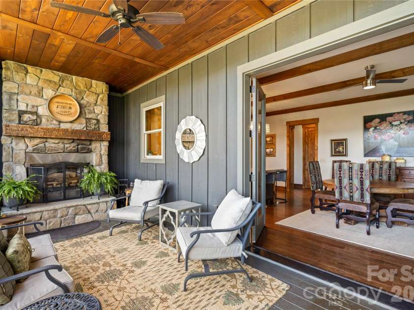 28 Gracie Lane, Weaverville, NC 28787.  MLS# CAR4361054, YatesRealty ID 16155. Designed for gathering, this space seamlessly connects indoor dining with outdoor living.