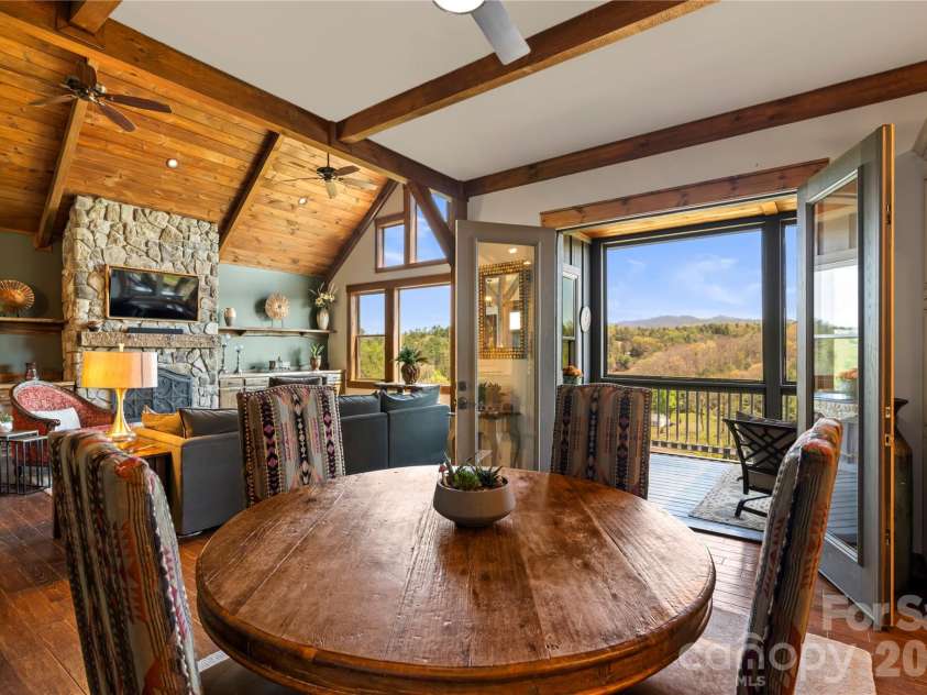 28 Gracie Lane, Weaverville, NC 28787.  MLS# CAR4361054, YatesRealty ID 16155. Dining area opens directly to the screened porch, creating an easy indoor-outdoor flow
