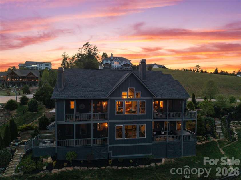 28 Gracie Lane, Weaverville, NC 28787.  MLS# CAR4361054, YatesRealty ID 16155. Expansive windows and multiple levels of outdoor living come to life at dusk.