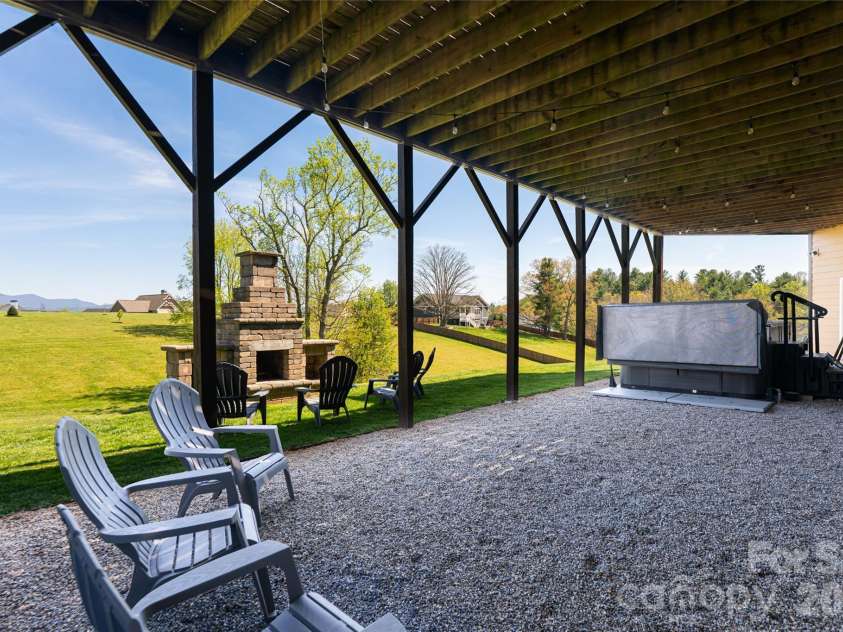 12 Horizon View Lane, Alexander, NC 28701.  MLS# CAR4373999, YatesRealty ID 16165. Lower Level terrace with fireplace and swim spa