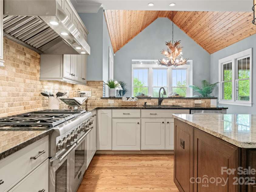 18420 Rosapenny Road, Charlotte, NC 28278.  MLS# CAR4240682, YatesRealty ID 16172. Chef's dual electric gas range, island and fantastic vaulted ceilings in dining room and living room. Check out the lake views