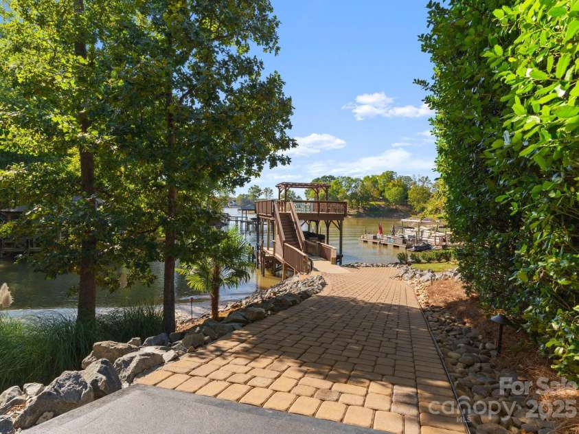 18420 Rosapenny Road, Charlotte, NC 28278.  MLS# CAR4240682, YatesRealty ID 16172. Take your golf cart of items to the boat and dock for entertaining