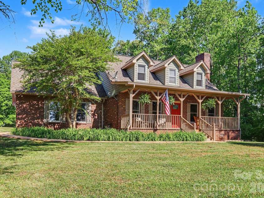 2040 Burke Road, Shelby, NC 28152.  MLS# CAR4367319, YatesRealty ID 16176. Beautiful brick farmhouse with rocking chair front porch!