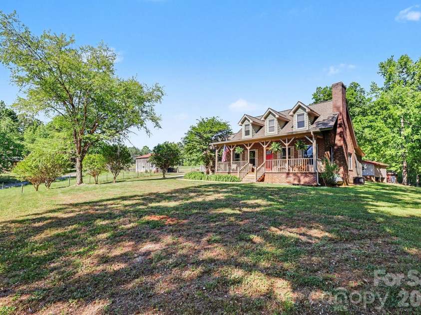 2040 Burke Road, Shelby, NC 28152.  MLS# CAR4367319, YatesRealty ID 16176. The cozy house sits on a gently sloping yard, surrounded by trees and open land.
