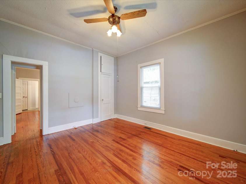 318 Chestnut Avenue, Kannapolis, NC 28081.  MLS# CAR4260562, YatesRealty ID 16180. Spacious bedroom 2 with ceiling fan and original hardwoods.