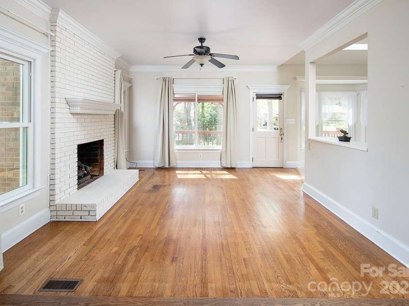7007 Chapparall Lane, Charlotte, NC 28215.  MLS# CAR4223263, YatesRealty ID 16192. Family Room with fireplace and views of backyard