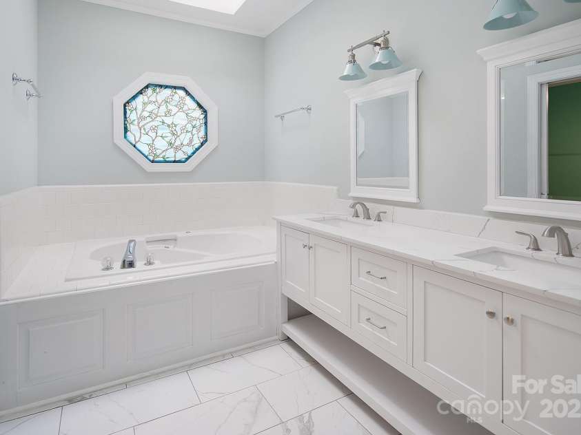 7007 Chapparall Lane, Charlotte, NC 28215.  MLS# CAR4223263, YatesRealty ID 16192. Fully Renovated Primary Bathroom with Hot Tub and custom window