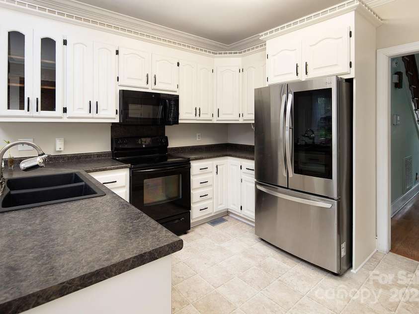 7007 Chapparall Lane, Charlotte, NC 28215.  MLS# CAR4223263, YatesRealty ID 16192. Kitchen with new refrigerator