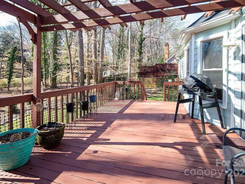 7007 Chapparall Lane, Charlotte, NC 28215.  MLS# CAR4223263, YatesRealty ID 16192. Pergola and deck off the back of the house overlooking beautiful yard