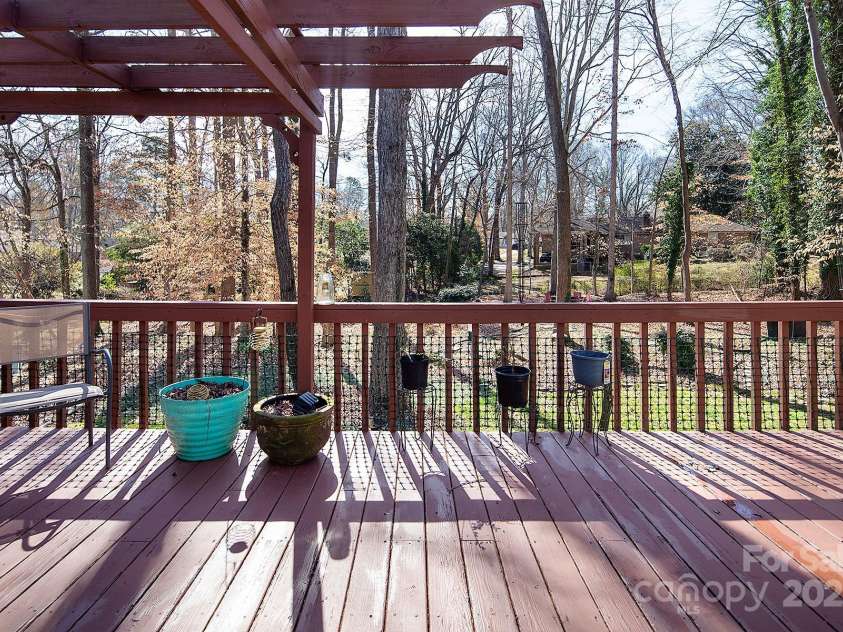 7007 Chapparall Lane, Charlotte, NC 28215.  MLS# CAR4223263, YatesRealty ID 16192. Pergola and deck off the back of the house overlooking beautiful yard