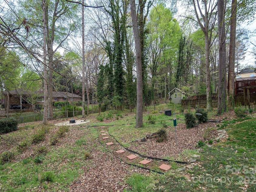 7007 Chapparall Lane, Charlotte, NC 28215.  MLS# CAR4223263, YatesRealty ID 16192. Well-maintained backyard with pathways