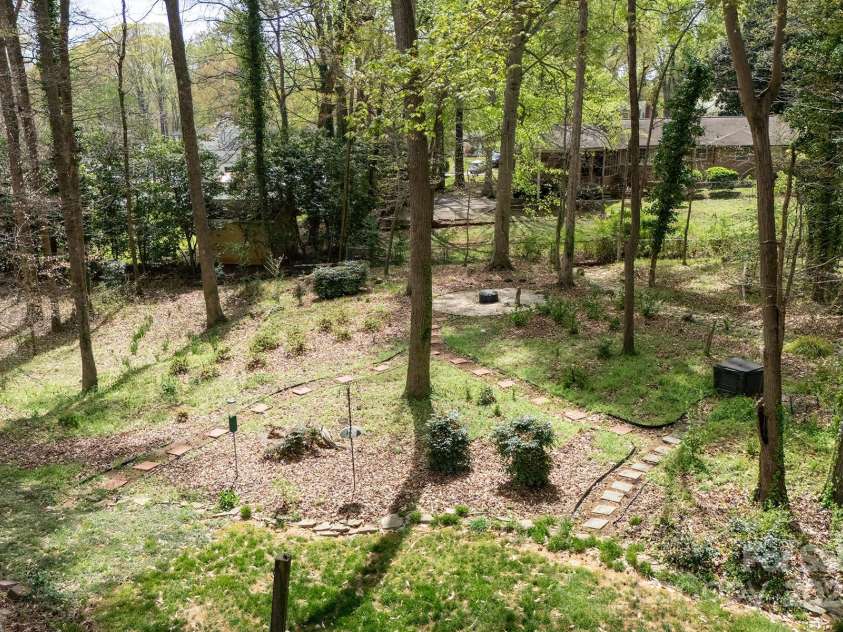 7007 Chapparall Lane, Charlotte, NC 28215.  MLS# CAR4223263, YatesRealty ID 16192. Well-maintained lush yard with firepit