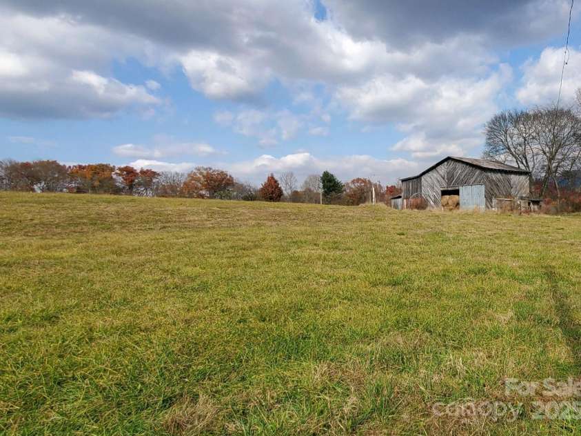 626 Fairview Loop, Hot Springs, NC 28743.  MLS# CAR4302454, YatesRealty ID 1621. Beautiful mountain meadow with its barn in the background.... adjacent to the property in the back side.