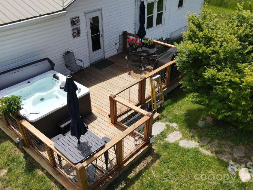 626 Fairview Loop, Hot Springs, NC 28743.  MLS# CAR4302454, YatesRealty ID 1621. Rear Deck with the grill and table on its right side.