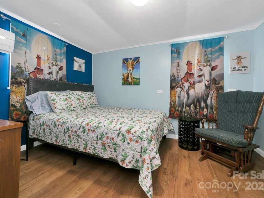 626 Fairview Loop, Hot Springs, NC 28743.  MLS# CAR4302454, YatesRealty ID 1621. The rear bedroom suite has its own thermostat and air-conditioning unit to allow a differential in temperature from the rest of the house if desired. The middle bedroom is alive with bunny rabbits in every corner! Light